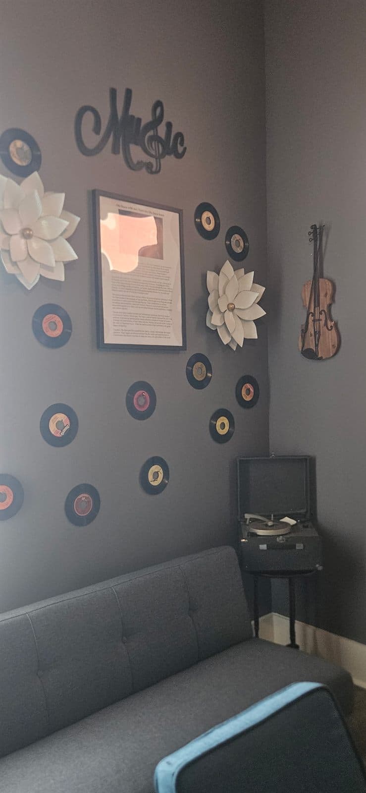 A guitar and records displayed on the wall of the music and storytelling room.