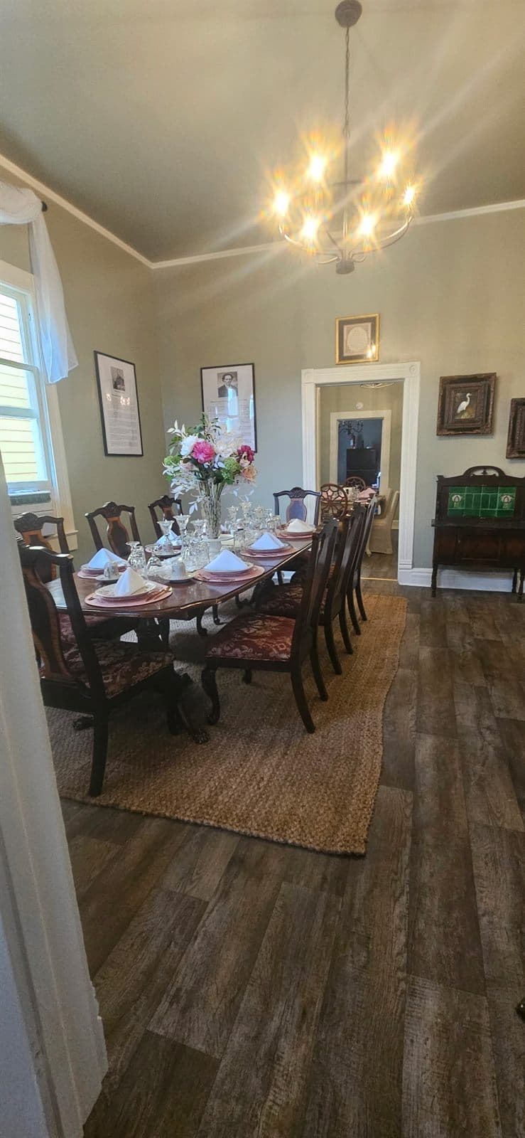 A table set for a gathering, with flowers and place settings down its length.