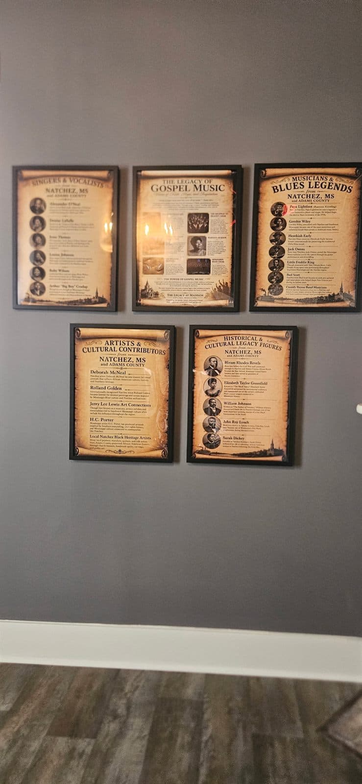 Framed documents and keepsakes arranged as a heritage exhibit.
